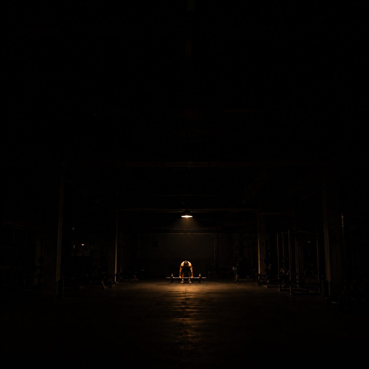 A lone lifter under one light at night